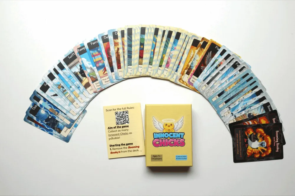 All 56 cards of the Innocent Edition fanned out around the box and rules leaflet